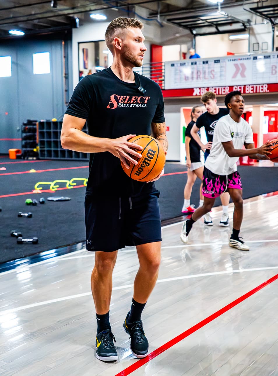 coach brandon holding a basketball