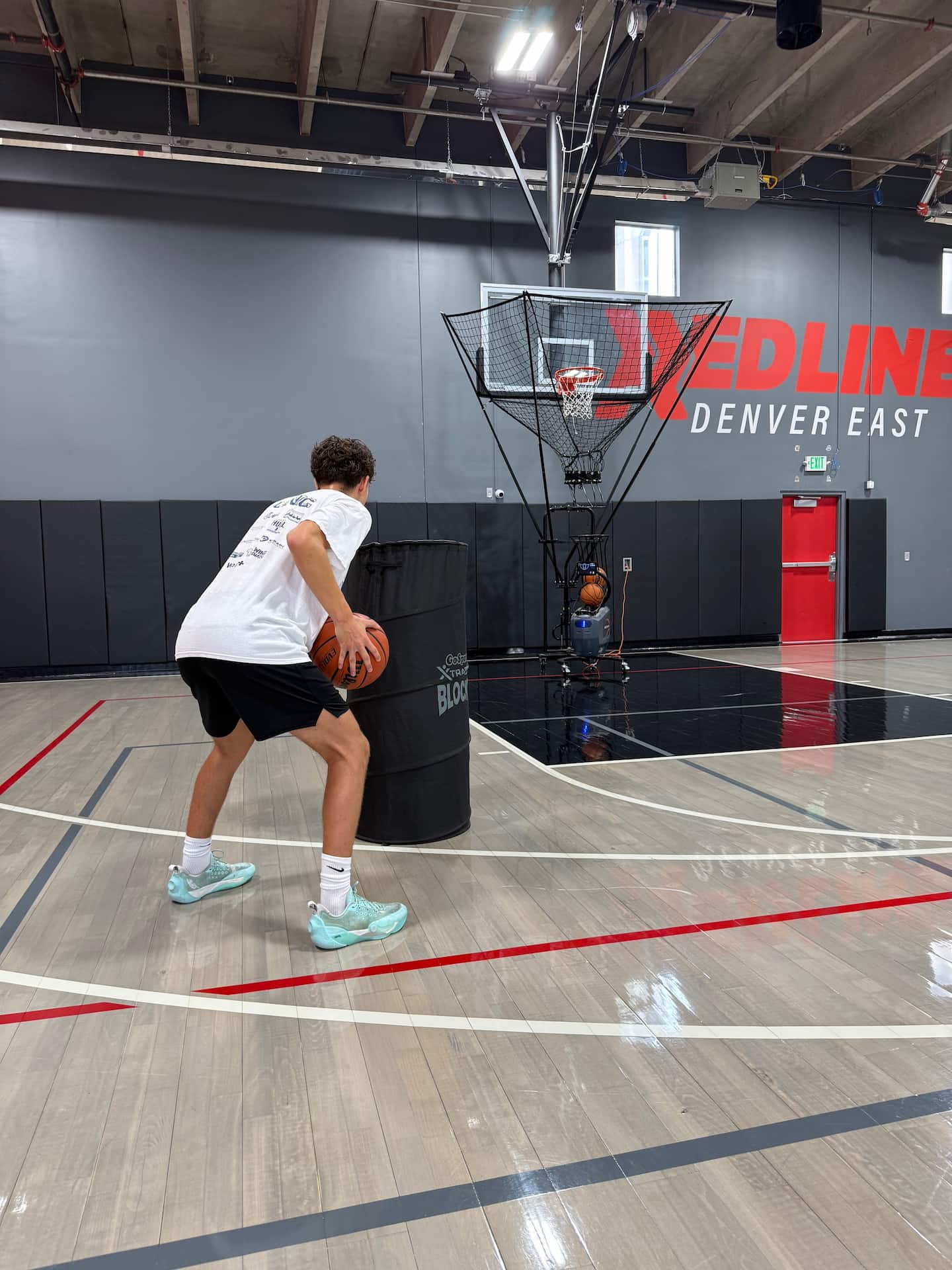 player practicing driving on with a cone and shooting machine