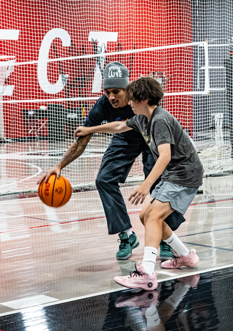 youth athlete defending a coach in basketball