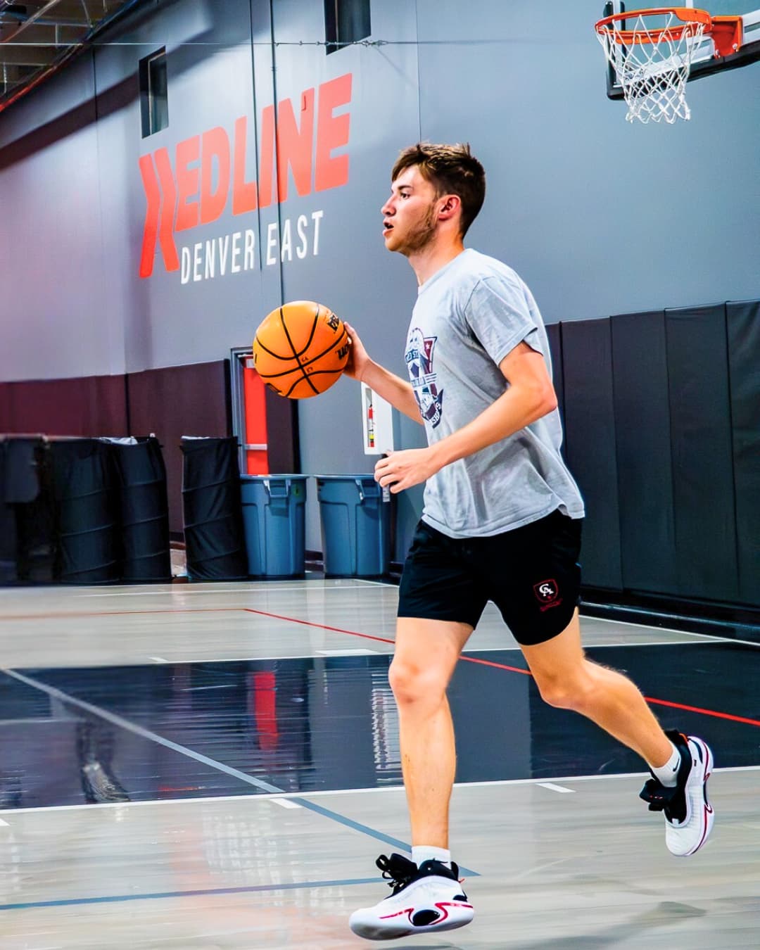 high school basketball player dribbling up the court