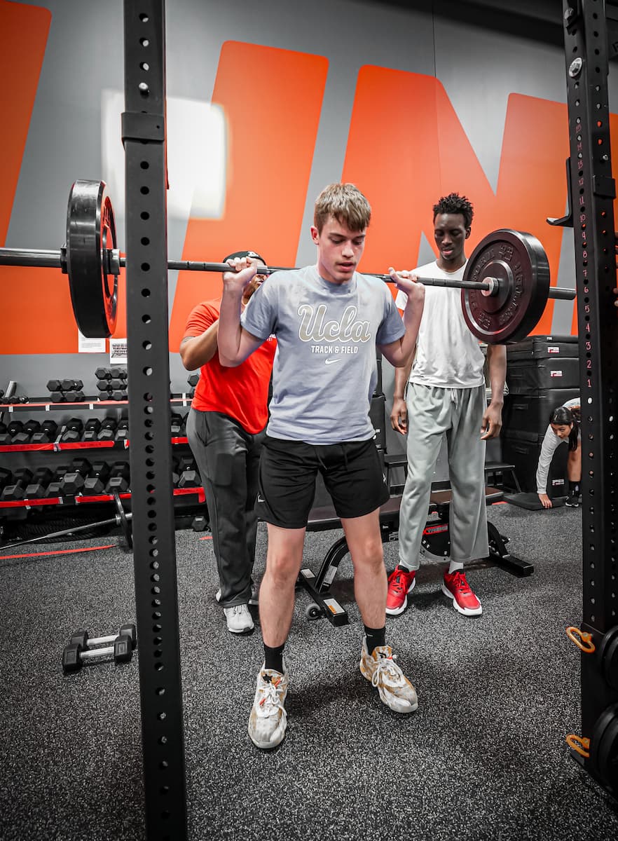 mens basketball player back squatting