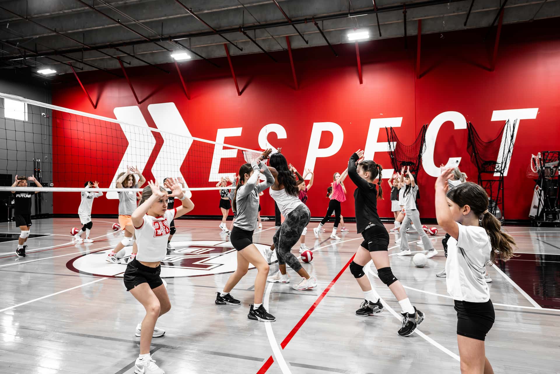 a group of volleyball players practice setting