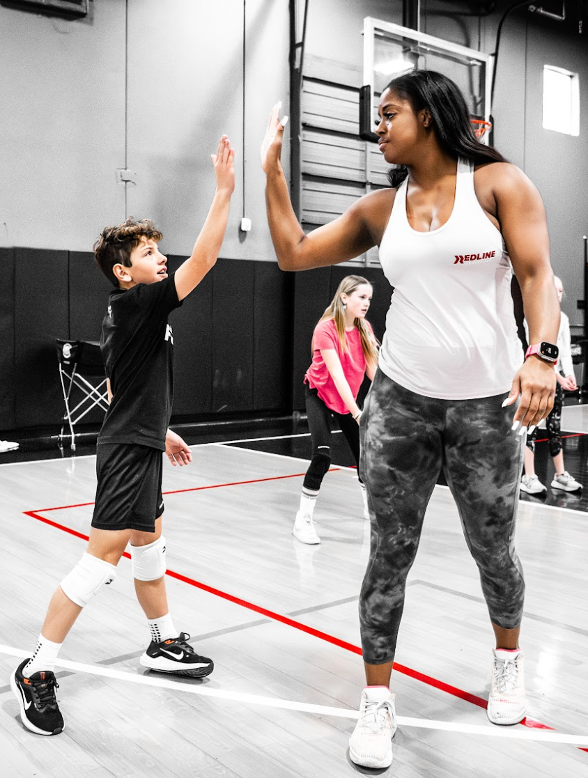 volleyball player high fives coach jenelle