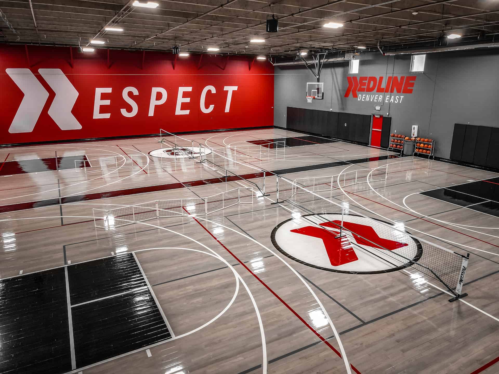 two basketball courts with pickleball nets set up