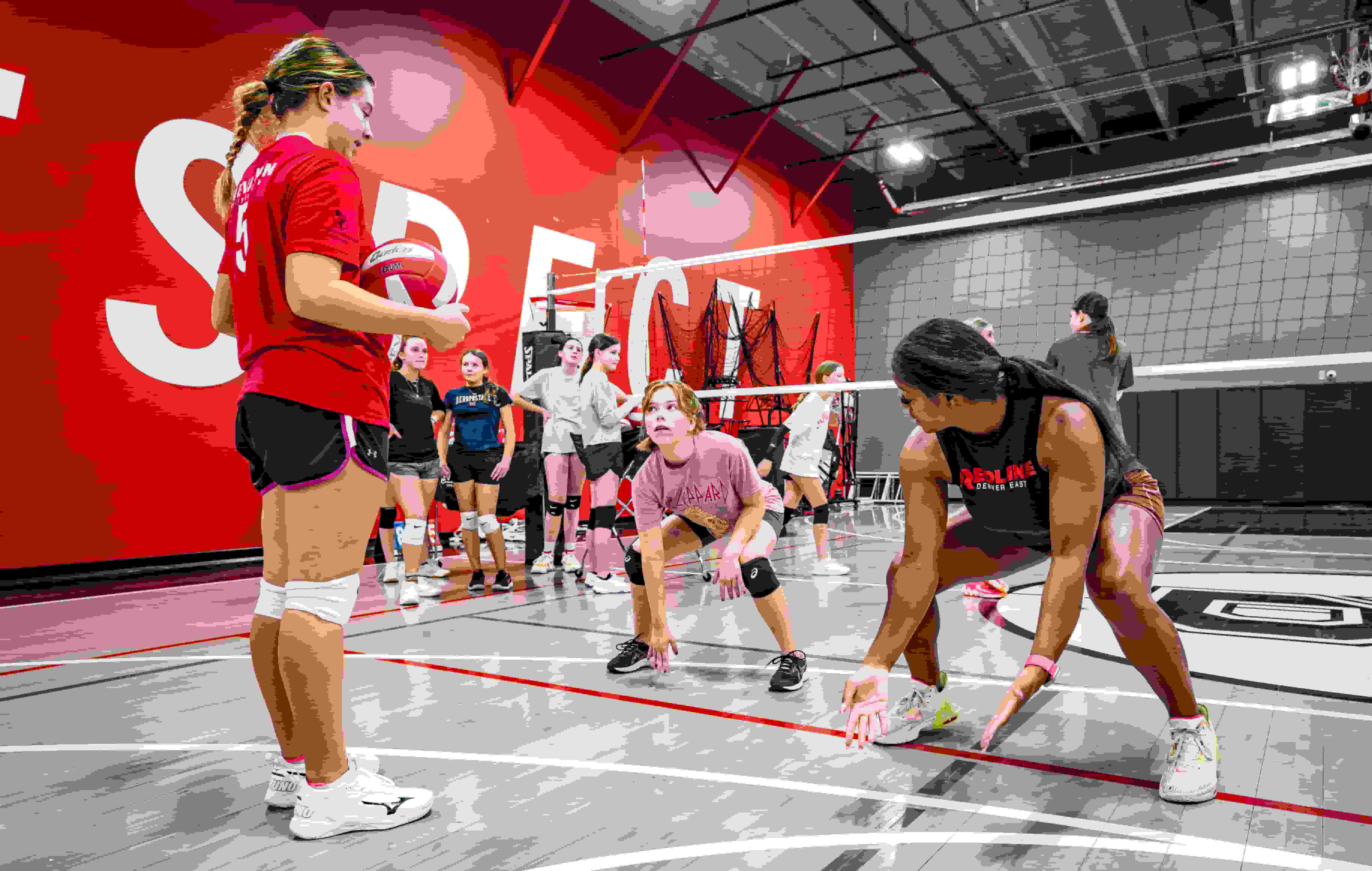 coach jenelle instructing volleyball players