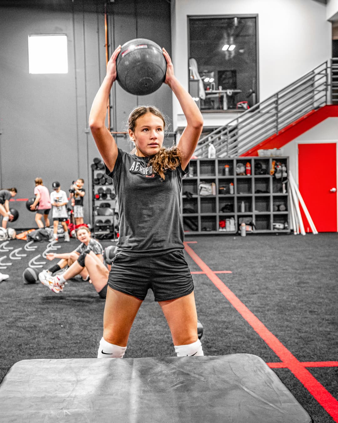 female athlete doing med ball slams