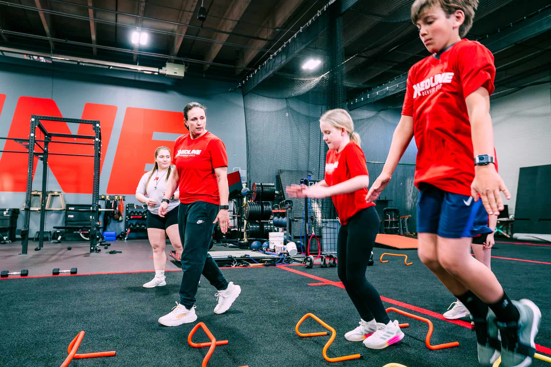 athletes jump over cones