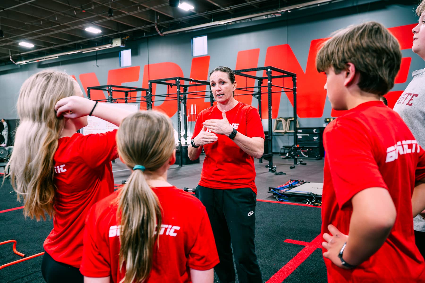 coach speaking to athletes about speed training drills