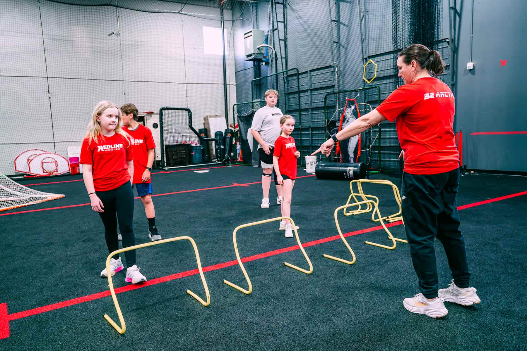 coach watching athletes perform speed training drills