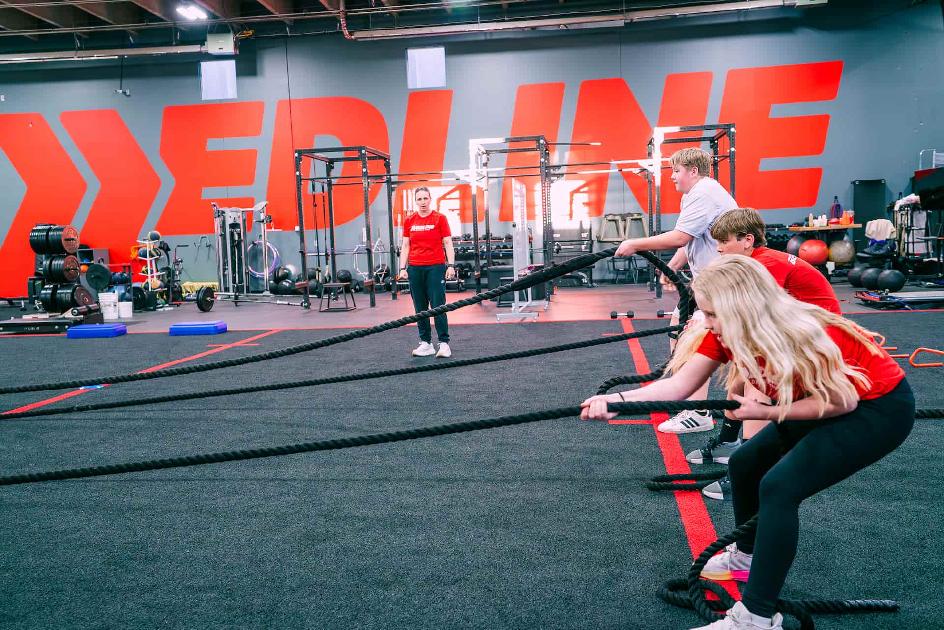 group of athletes doing rope pulls