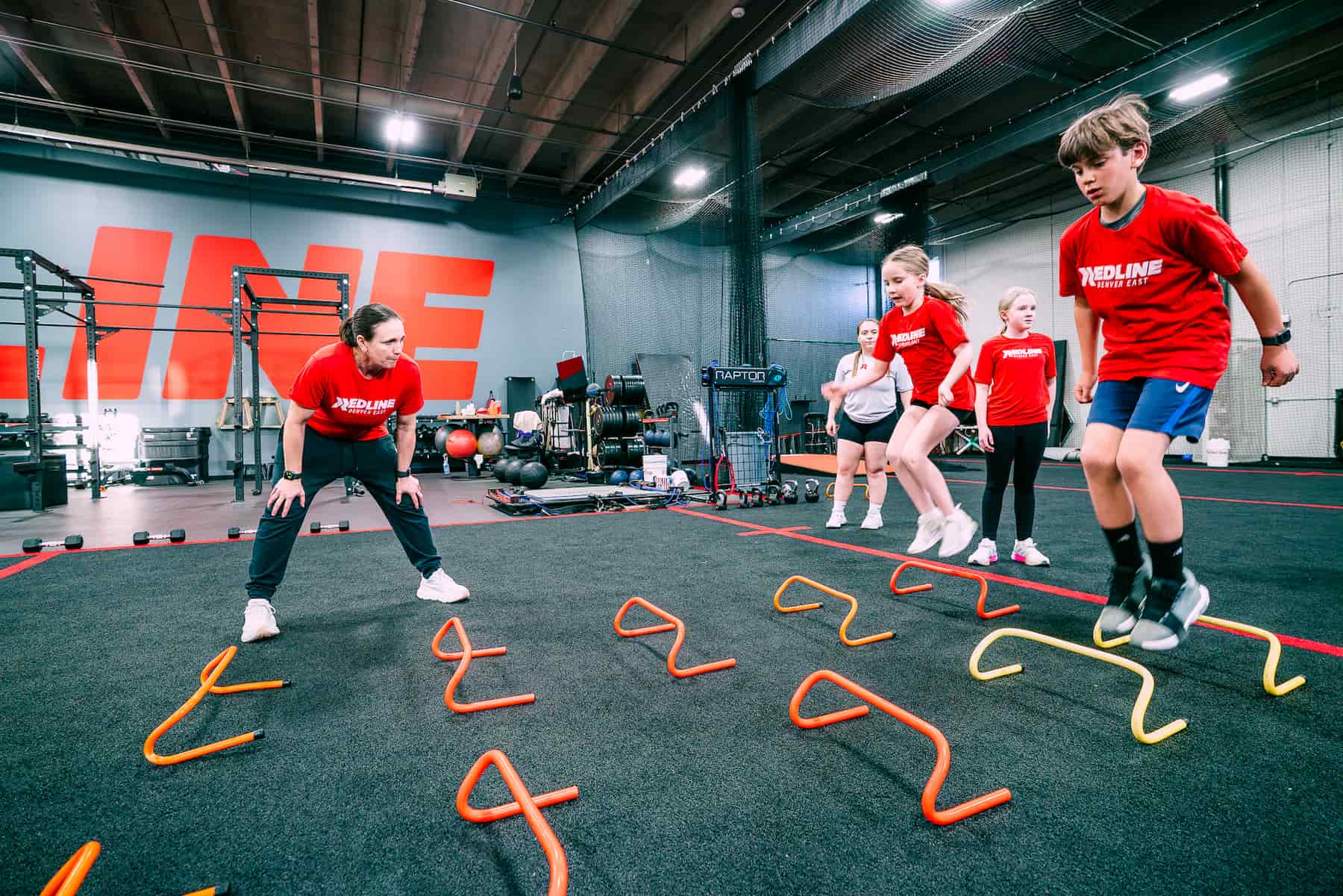 coach watching athletes perform speed training drills